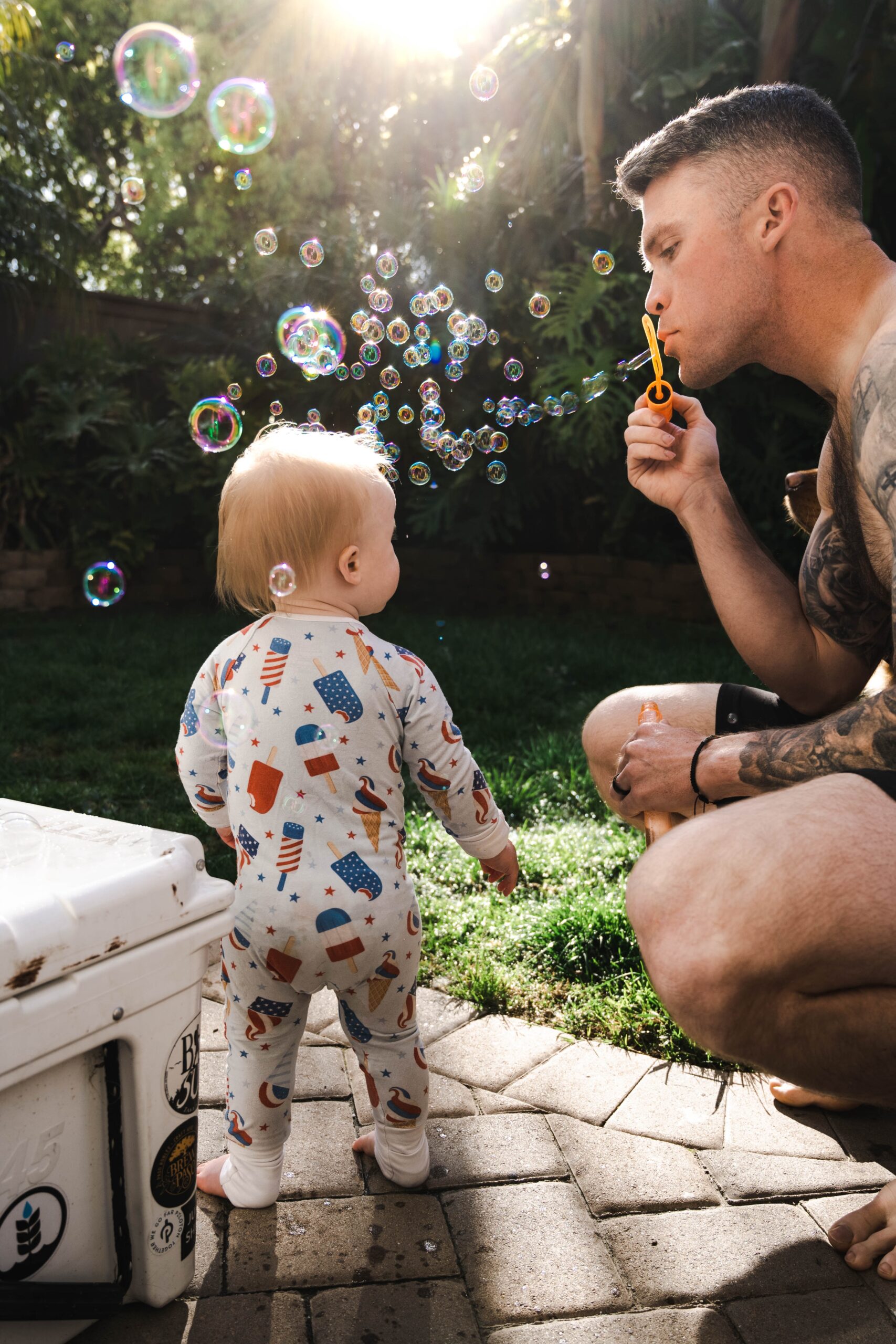 dad and baby blowing bubbles