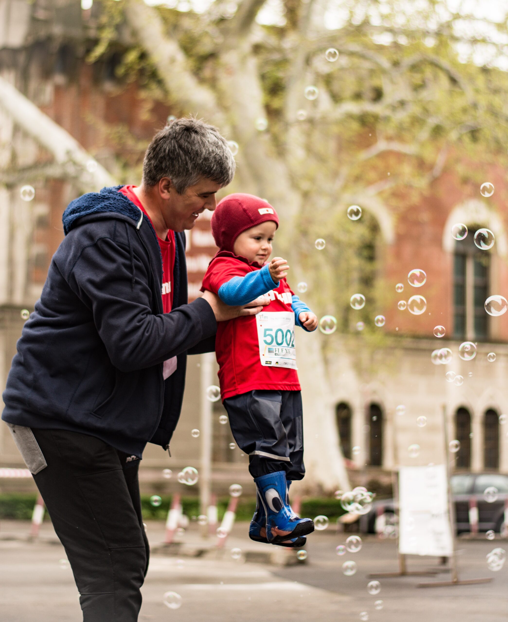 dad and boy blowing bubblers